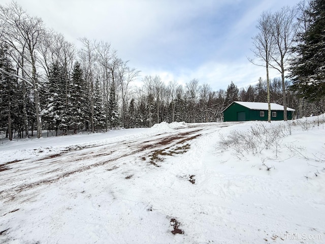 snowy yard featuring an outdoor structure