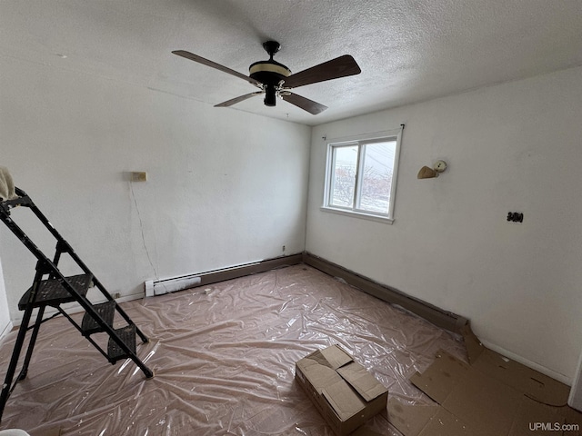 unfurnished room featuring ceiling fan, a baseboard radiator, and a textured ceiling