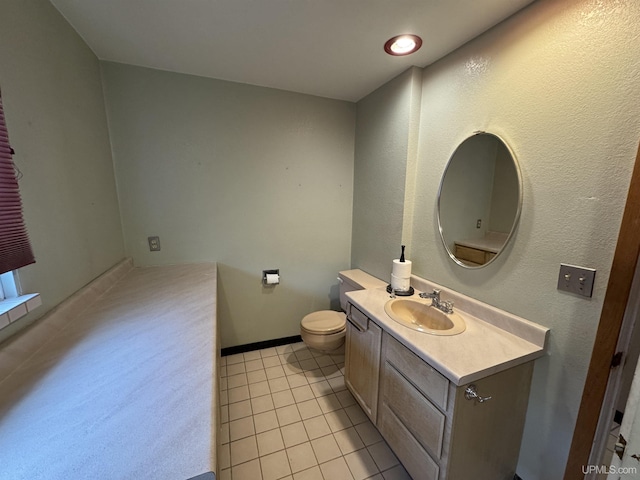 bathroom featuring tile patterned floors, vanity, and toilet