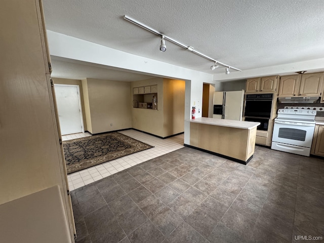 kitchen with light brown cabinets, rail lighting, kitchen peninsula, a textured ceiling, and white appliances