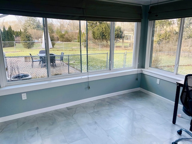 unfurnished sunroom featuring a healthy amount of sunlight