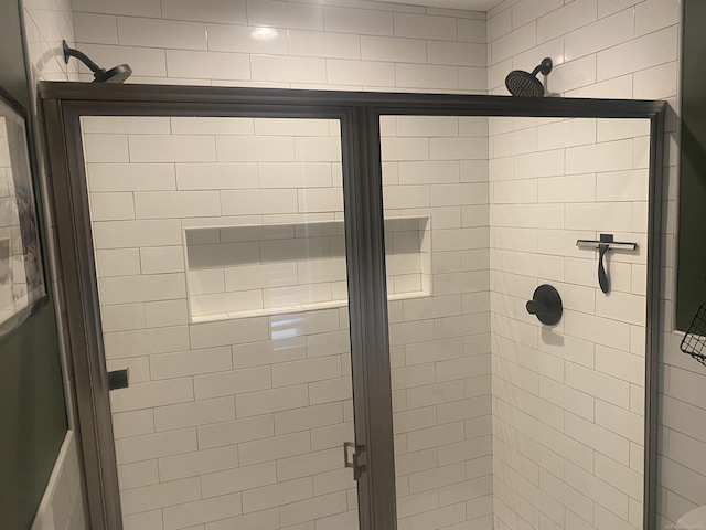 bathroom featuring a shower with door