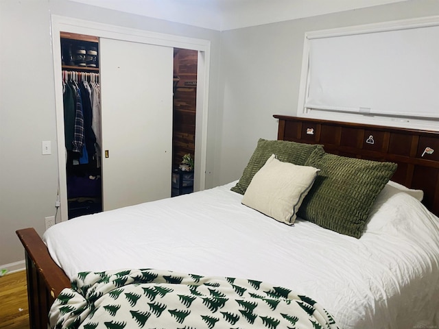 bedroom featuring hardwood / wood-style floors and a closet