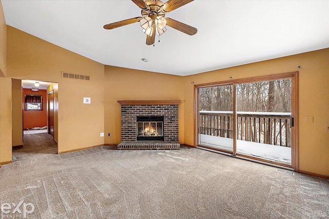 unfurnished living room with ceiling fan, carpet floors, a fireplace, and vaulted ceiling