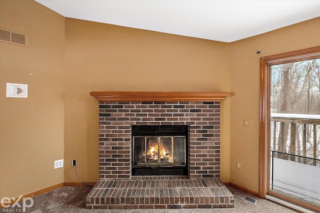 interior details featuring a fireplace and carpet flooring