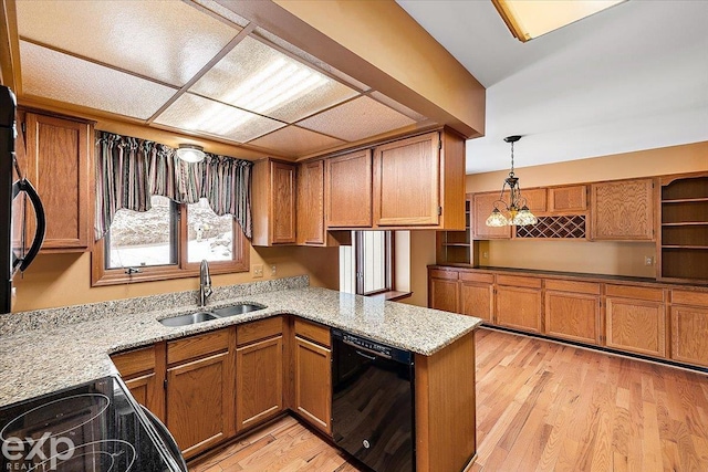 kitchen with kitchen peninsula, dishwasher, sink, and light hardwood / wood-style floors