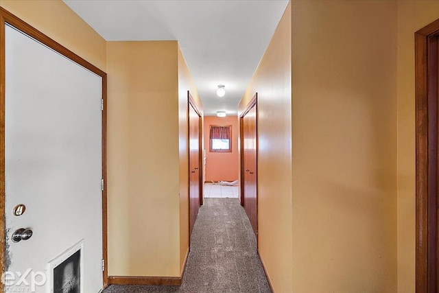 corridor with dark colored carpet