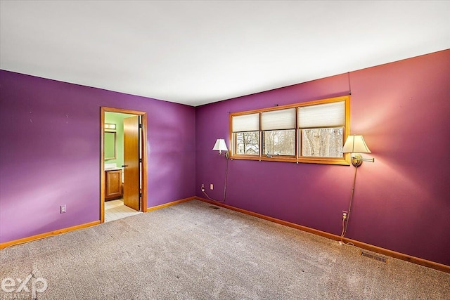 spare room featuring light colored carpet