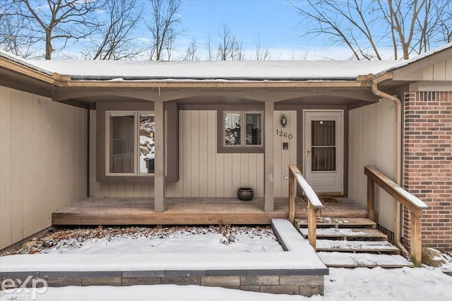 view of snow covered property entrance