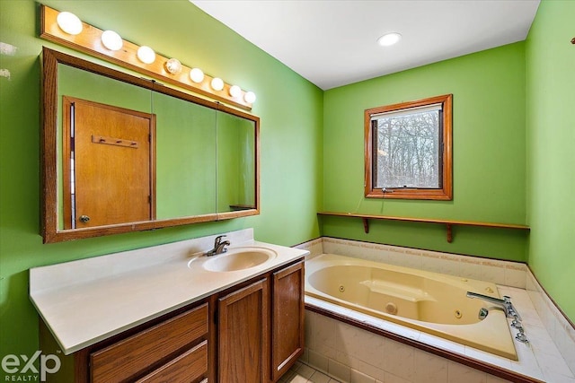 bathroom featuring vanity and a relaxing tiled tub