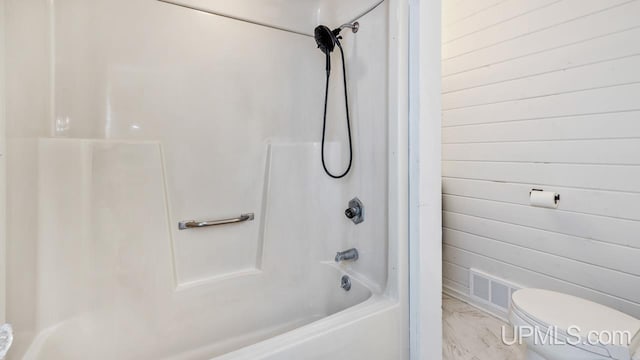 bathroom with toilet and tub / shower combination