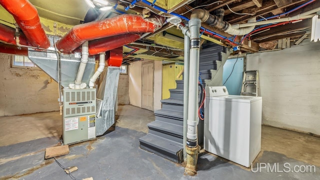 basement featuring washer / dryer and heating unit