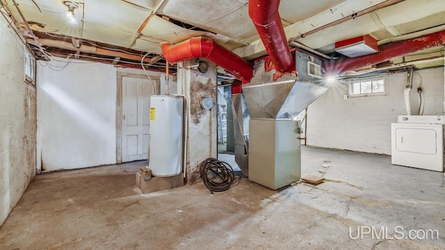 basement with washer / clothes dryer, water heater, and heating unit