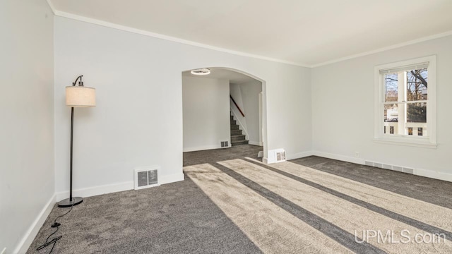 carpeted empty room featuring crown molding