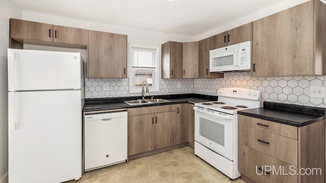 kitchen with tasteful backsplash, sink, and white appliances