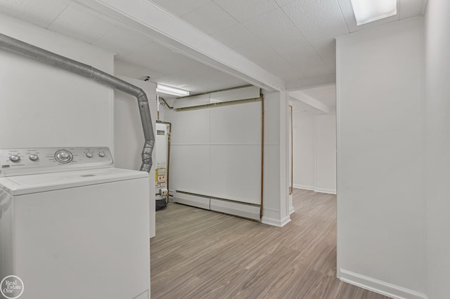 washroom featuring washer / dryer, gas water heater, light hardwood / wood-style flooring, and baseboard heating