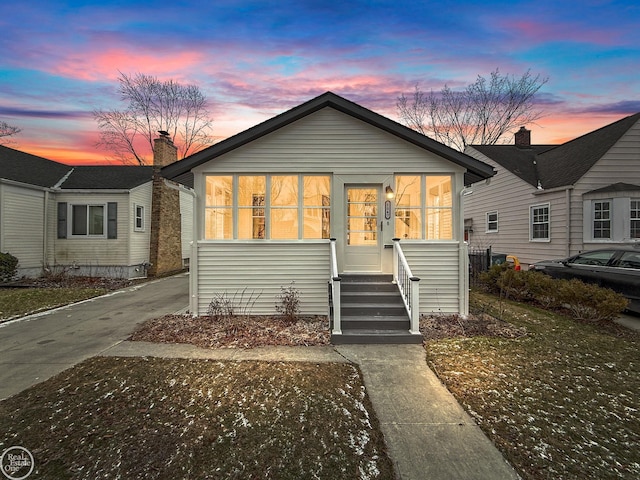 view of front of house with a sunroom