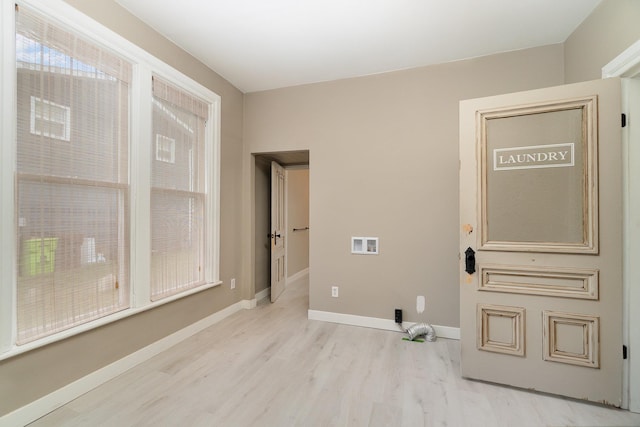 washroom featuring hookup for a washing machine and light hardwood / wood-style flooring