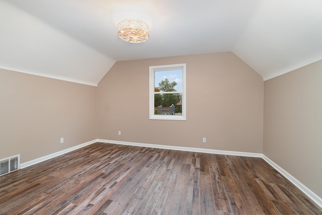 bonus room with dark hardwood / wood-style flooring and lofted ceiling