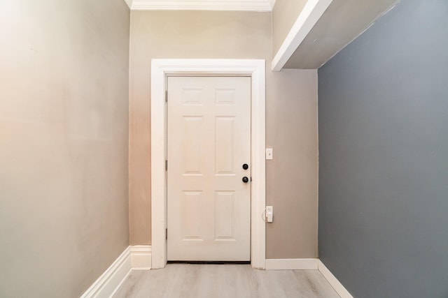 doorway to outside with light hardwood / wood-style flooring and crown molding