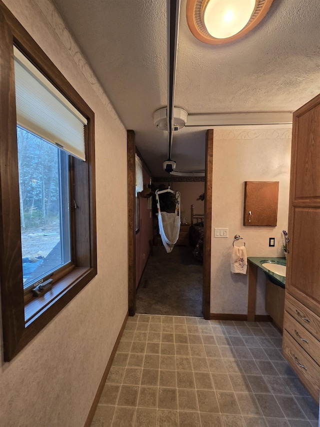 corridor with a textured ceiling