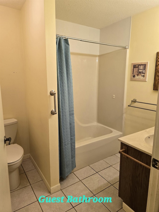 full bathroom featuring shower / bath combination with curtain, a textured ceiling, vanity, tile patterned flooring, and toilet