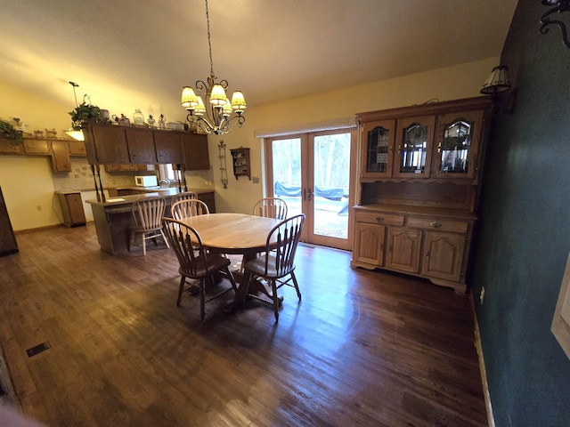 dining room with a chandelier and dark hardwood / wood-style floors