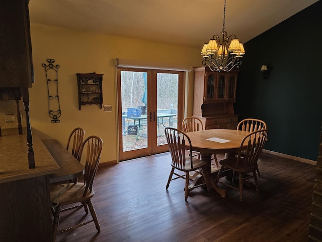 dining area featuring a chandelier, french doors, and dark hardwood / wood-style floors