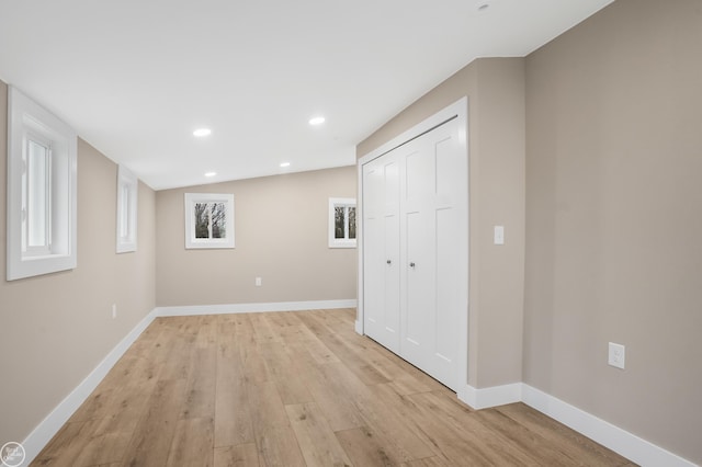 basement with light hardwood / wood-style floors