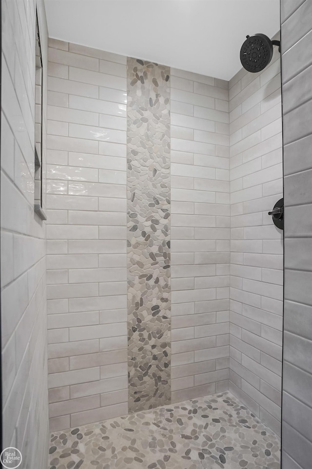 bathroom with tiled shower