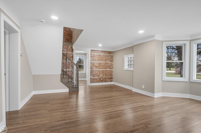 unfurnished living room with hardwood / wood-style flooring and plenty of natural light