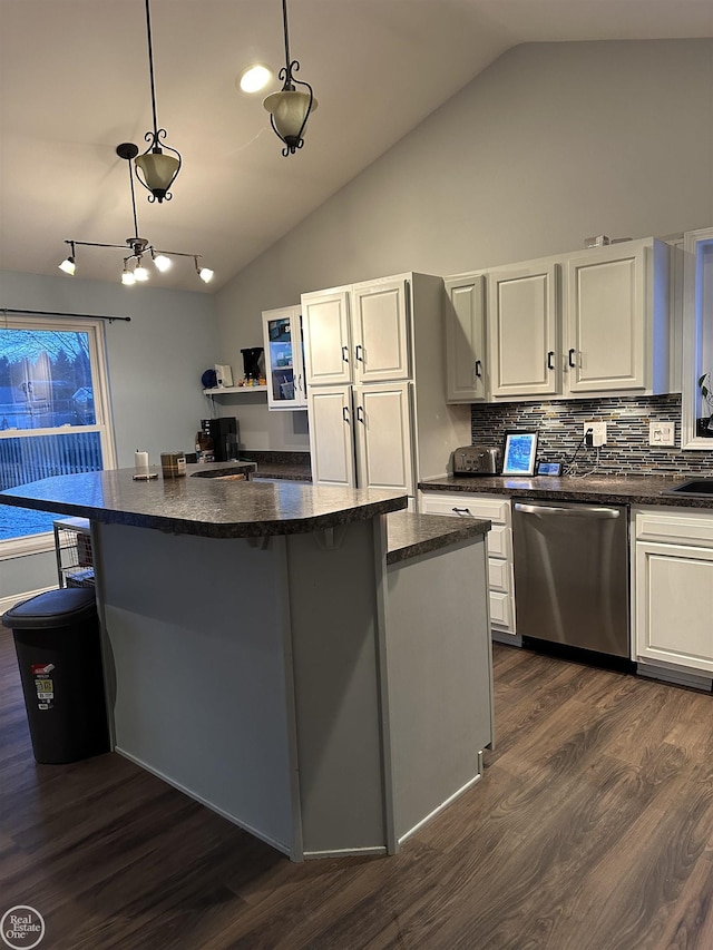 kitchen with dishwasher, hanging light fixtures, tasteful backsplash, dark hardwood / wood-style floors, and vaulted ceiling