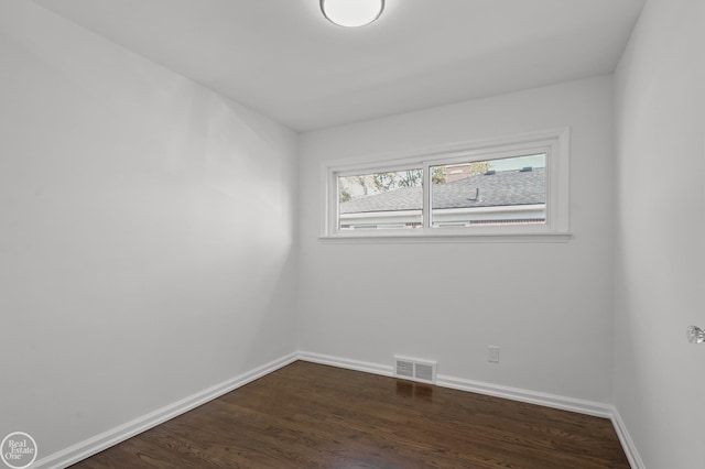 spare room featuring dark hardwood / wood-style flooring