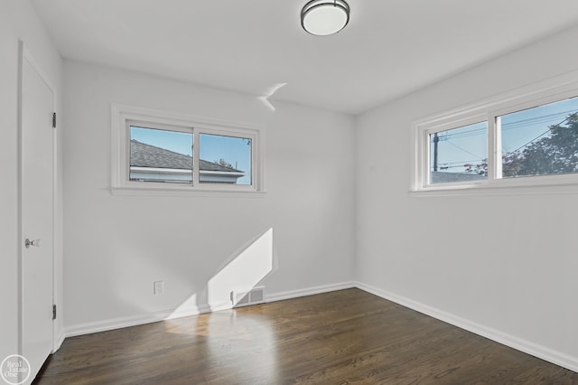 unfurnished room featuring dark wood-type flooring