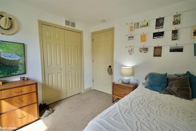 bedroom featuring light colored carpet and a closet