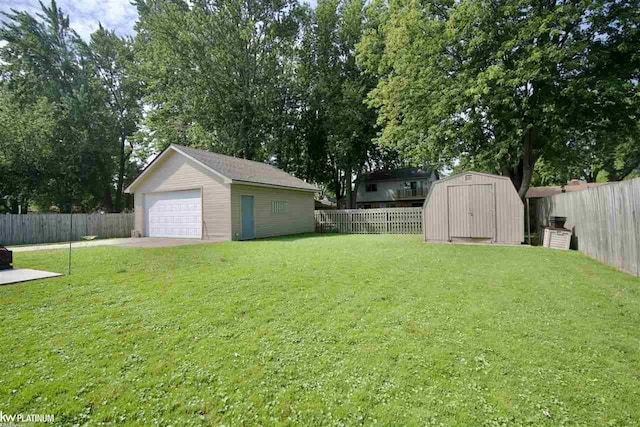 view of yard with a garage and a storage unit