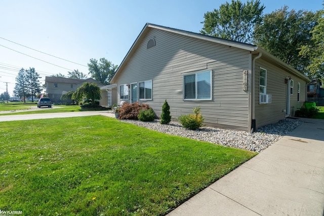 view of side of property with a yard