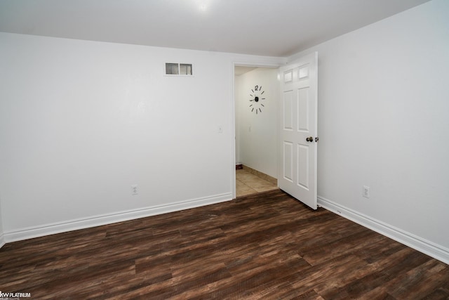 empty room featuring dark wood-type flooring