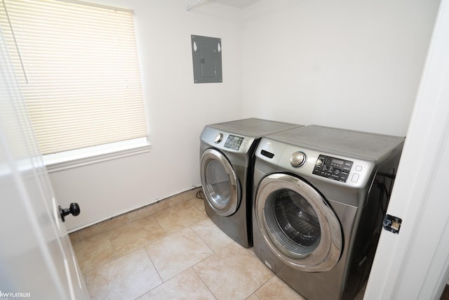 washroom with independent washer and dryer, electric panel, and light tile patterned floors