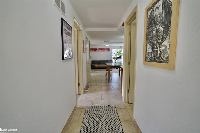 hall featuring light tile patterned flooring