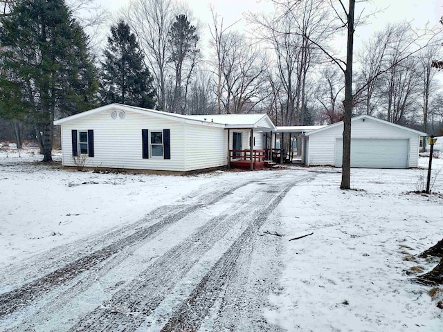 view of front of house with a garage and an outbuilding