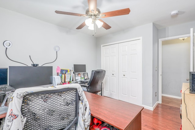 bedroom with hardwood / wood-style flooring, ceiling fan, and a closet