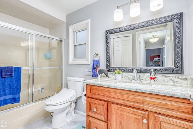 full bathroom with tile patterned flooring, vanity, toilet, and shower / bath combination with glass door