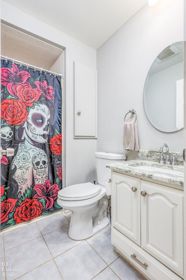 bathroom featuring tile patterned floors, vanity, and toilet