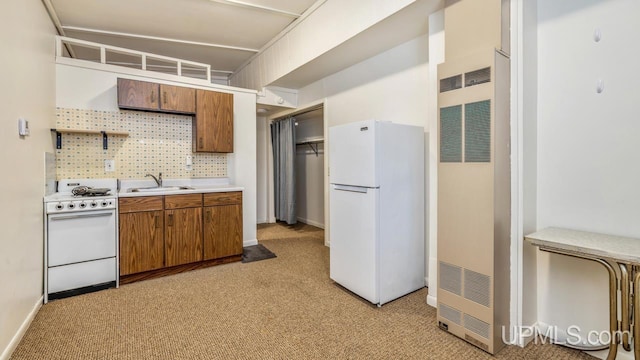 kitchen with light carpet, decorative backsplash, white appliances, and sink