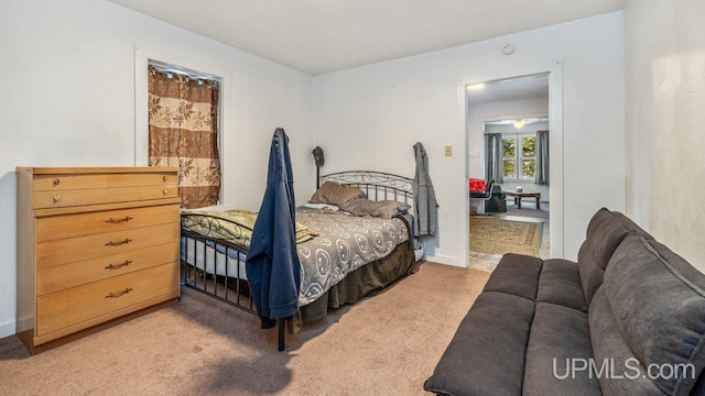 bedroom featuring light colored carpet