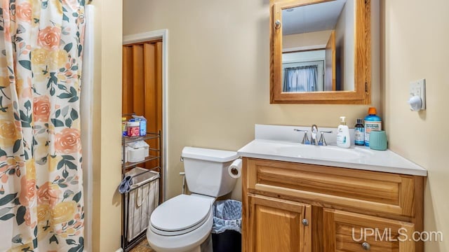 bathroom with vanity, toilet, and walk in shower