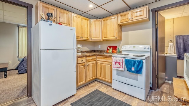 kitchen with light brown cabinetry, a drop ceiling, white appliances, and light hardwood / wood-style flooring