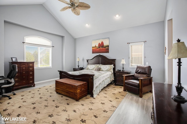 bedroom featuring ceiling fan, light hardwood / wood-style flooring, and high vaulted ceiling