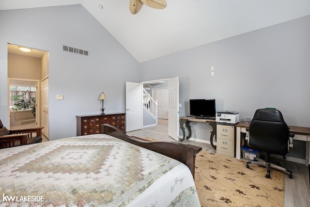 bedroom featuring light hardwood / wood-style flooring, high vaulted ceiling, and ceiling fan